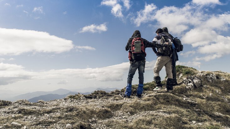 3 hikers on mountaintop